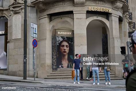 Tourists stand in front of Burberry store in Avenida dos Aliados 